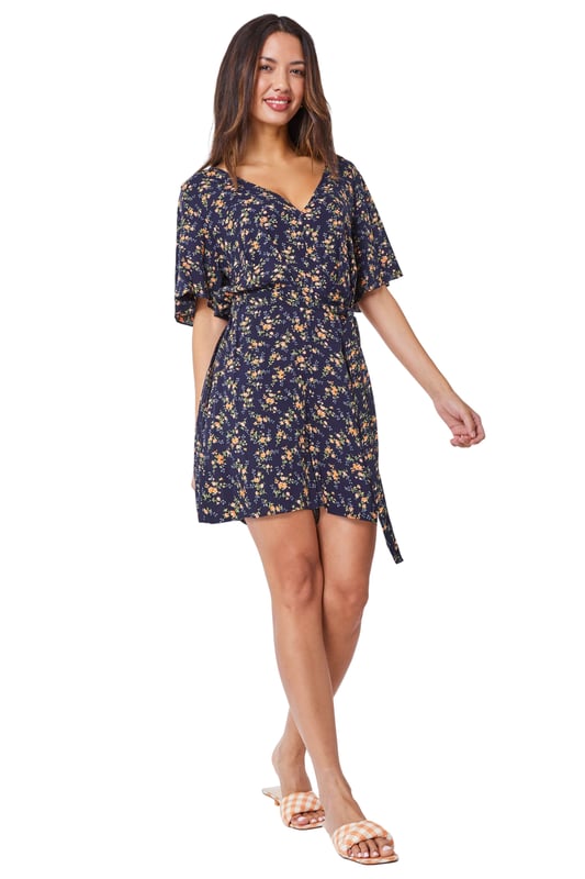 Ditsy Floral Print Playsuit from Roman. Enjoy the light and airy summer vibes with this ditsy floral print playsuit. Designed with a v neckline and short sleeves, this style is the perfect addition this season. Pair it with a cross body bag, sandals or trainers for those day meals out with friends and family. Why not bring a cardi along with you, perfect for the those fresh evenings out by the beach, what-ever the weather, where-ever you go, this little number is an easy go-to!