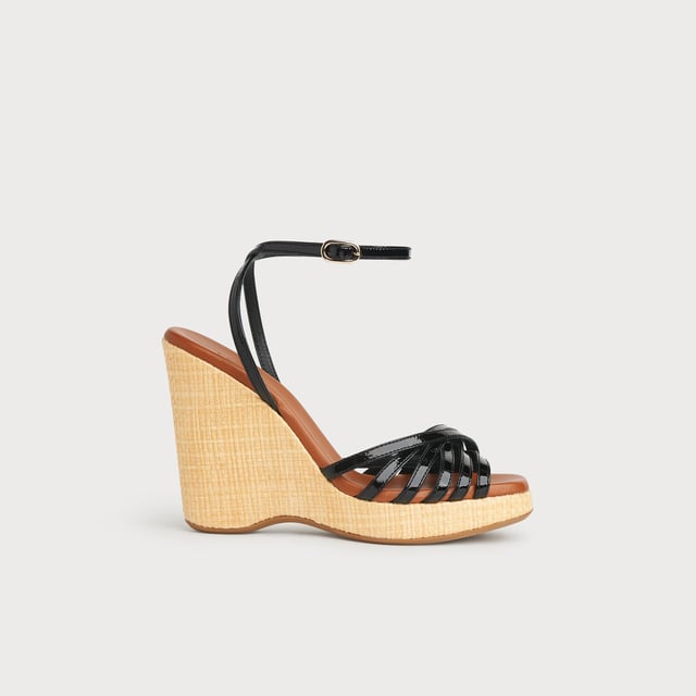 LK Bennett SOLANGE Sandals, Black With a hint of Seventies' playfulness, our Solange wedges balance height and comfort. Crafted in Italy from black patent leather, they have a crossover multi-strap design, a delicate ankle strap and a beige raffia 110mm wedge sole. Perfect with summer's cool cotton and linen skirts and dresses, they're also great with wide leg trousers.