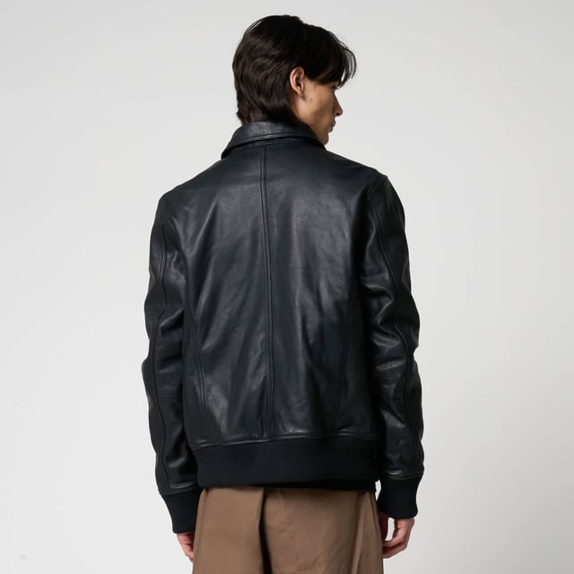 Men’s Barneys Originals goat leather bomber jacket. Features classic patch pockets, a Harrington-style collar, and knit rib detailing on the cuffs and hem for a timeless, structured fit.