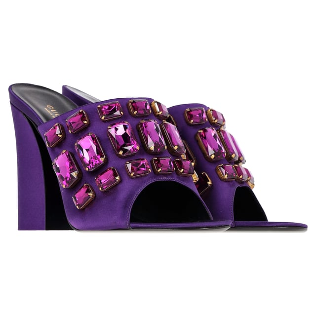 VINTAGE, RRP AS NEW

A perfect blend of luxury, style, and comfort, these designer mules are made using quality materials and elegantly frame your feet. They are designed with round open toes, block heels, and crystals that make them look elegant. They can be paired with a host of outfits from your wardrobe.

with box.

Gucci Tessa Crystal Embellished Peep Toe Mules in Purple Satin 
Condition: Excellent
Signs of wear: Include Box., No visible sign of wear. No Mark at insole.,  Very light mark at soles.
Packaging: Box
Color: Violet | purple
Material: Satin | crepe-satin
Size: EU | 39.5 / US9.5
Measurements: Heel height: 110; Insole length: 270
SKU: NAPPUGBSH422710W