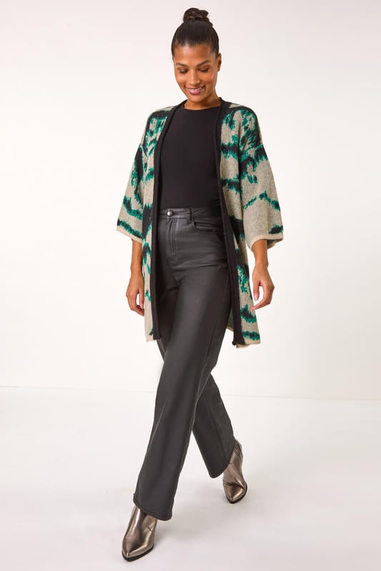 Abstract Print Knit Cover Up from Roman. Stay stylish and warm with this abstract knit cover up, perfect for the Autumn/Winter season. Designed with an eye catching abstract knit pattern, this cover up features an easy edge to edge front and chic short sleeves for a versatile look. Layer it over a long sleeve top and jeans for a fashionable and cosy outfit.