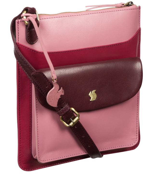 Handcrafted from genuine leather, the 'Lauryn' cross body bag from Conkca London features a beautifully textured finish. A zip-over top secures a central compartment lined with 100% untreated cotton which is complemented by two interior pockets, ideal for your phone and keys. Additional storage space is provided by two full-length pockets alongside a magnetic press stud secured front pocket. Finshed with an adjustable leather strap and adorned with the inimiatable Conkca London squirrel charm.