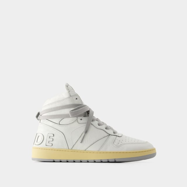 Presentamos las zapatillas Rhecess de Rhude, donde la frescura urbana se une a la comodidad contemporánea. Estas zapatillas fusionan a la perfección un diseño moderno con un guiño al estilo streetwear, mostrando una silueta única perfecta para ir a la moda statement. Para elevar tu look con estas zapatillas statement, considéralas la base de un conjunto moderno de inspiración callejera. Combínalas con unos vaqueros desgastados, una sudadera con capucha de estampado gráfico y unas gafas de sol atrevidas para conseguir un look vanguardista sin esfuerzo, perfecto para un día con amigos o una noche informal en la ciudad. Rhude Las zapatillas Rhecess de brand ejemplifican el compromiso de la marca con la calidad y la moda, ofreciéndote una opción de calzado distintiva y versátil que combina sin esfuerzo el encanto moderno con el estilo urbano. Sal con confianza, mostrando tu sensibilidad única por la moda y tu estilo de entrenador contemporáneo. Colores: Blanco - Blanco/Blanco. Material principal: piel de ternero lisa. Material de la suela: caucho. Material del forro: algodón. Cierre: cordones en la parte superior. Forma de la punta: almendra. Ajuste: fiel a la talla - Talla: