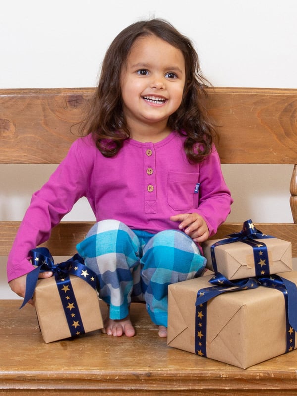 We're delighted to share these very special organic cotton pyjamas that will help your little one snooze in comfort and style. Offering the softest, single jersey grandad style top with coconut button details in this season's orchid pink, and Kite's super-soft tonal blue and cream brushed check trousers for next-to-skin comfort and kindness.