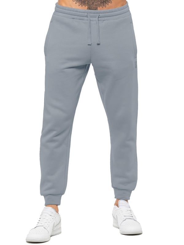 Experience ultimate comfort in our Enzo Mens Regular Fit Joggers. Made with a soft brushed back inner fleece lining, these joggers are perfect for casual wear. The cuffed leg design and elasticated waist with drawstrings provide the perfect fit. With 2 side slash pockets, you can easily carry your essentials.