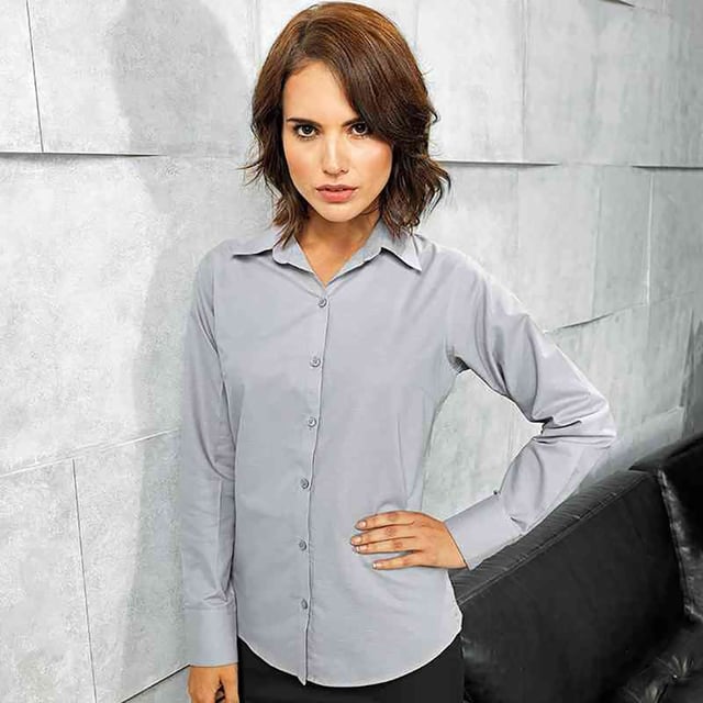 Ladies signature Oxford long sleeve Easycare blouse with wrinkle free finish for a smart and professional appearance. Soft collar styling. Rounded bottom hem. Fitted styling with bust and back darts. Pearlised buttons on light blue and white shirt, self c. Fabric:70% Cotton, 30% Polyester, cotton rich Oxford weave Weight: 135gsm. 8, 10, 12, 14, 16, 18, 20, 22, 24