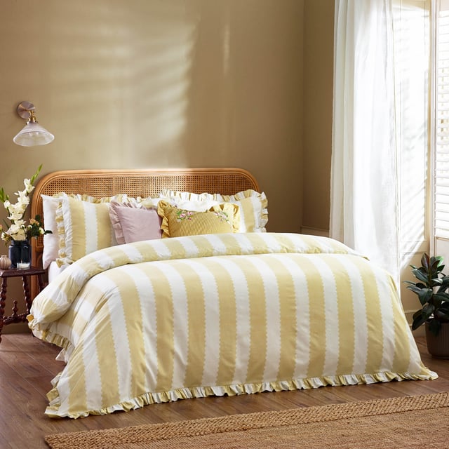 Bring a touch of elegance to your bedroom with the Birdie Stripe Ruffle Duvet Cover Set. Crafted from cotton-rich fabric with a 180 thread count, this duvet cover set offers a blend of comfort and style. The delicate ruffle trim nods to British heritage while adding a subtle hint of cottagecore charm. Its reversible design features classic stripes on both sides, offering versatility to match your décor. Designed for those who appreciate classic prints and patterns, this timeless bedding will become the centrepiece of your room, creating a serene retreat inspired by the natural world. 200 x 200cm