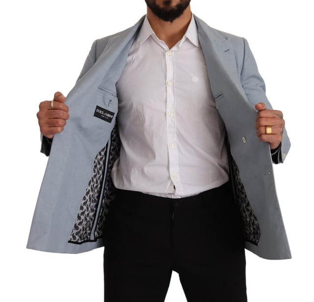 Brand: Dolce & Gabbana
  Style: Double breasted
  Fitting: Slim fit
  Colour: Light Blue
  Made in Italy
  Material: 60% Cotton 40% Flax
  Lining: 100% Viscose
  Logo details
  Very exclusive and high craftsmanship
Material: 60% Cotton 40% Flax