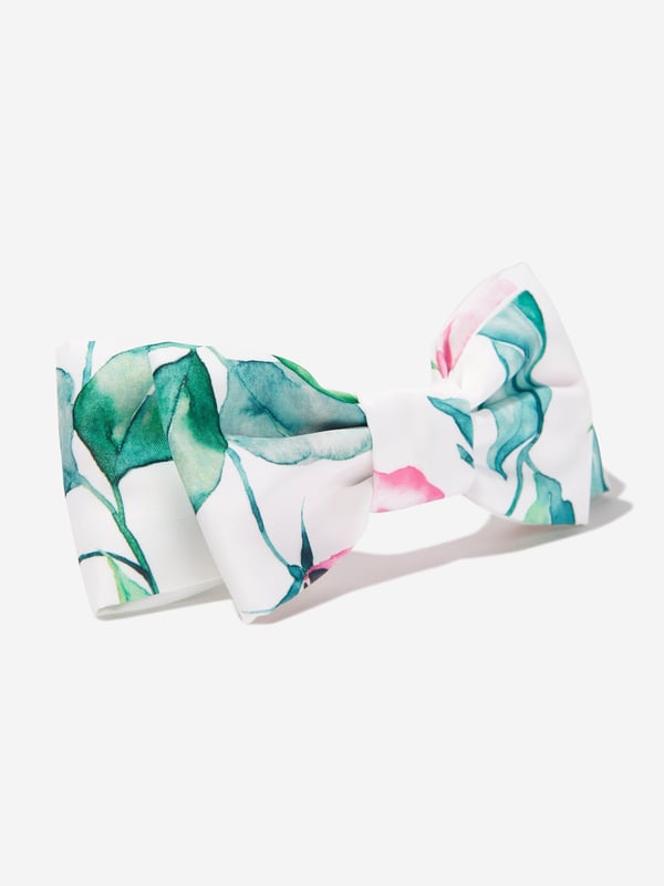 Californian label Mama Luma depict beautiful designs via their ethically sourced fabrics. This girls green white headband is reflective of the label's fine detailing and handmade construction. Envisioned with a green and pink leaves pattern, an enlarged bow and plastic inner structure. She will look and feel divine.  ‚ Handmade
