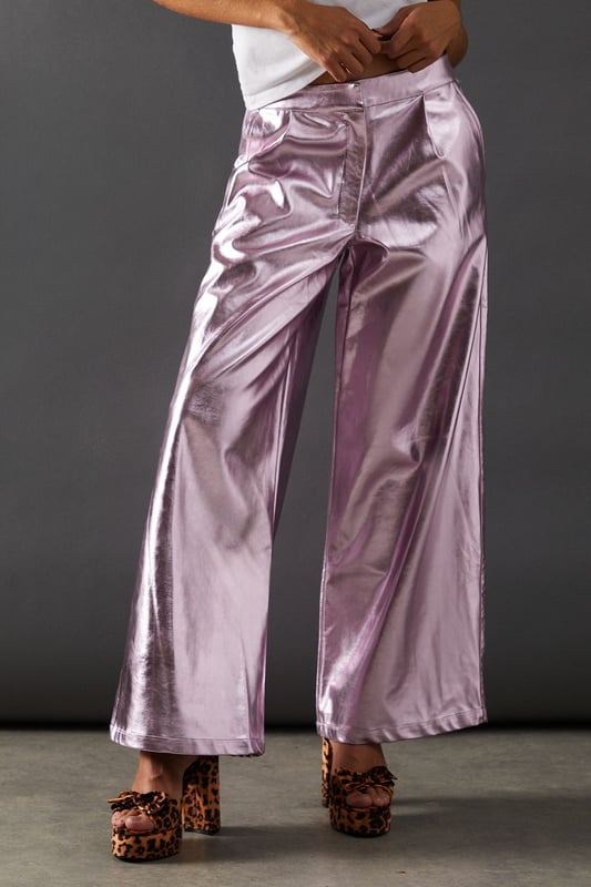 Eye-catching metallic finish for a bold statement
        Wide leg silhouette for a comfortable and trendy fit
        High-waisted design accentuates the waistline
        Front zip and button fastening for a secure fit
        Versatile style suitable for various occasions
    
    Make a dazzling entrance with these striking metallic wide leg jeans from Warehouse. Perfect for those who dare to stand out, these trousers combine comfort with high-impact style. The wide leg cut offers freedom of movement while creating a fashionable silhouette. For a night out on the town, pair these show-stopping trousers with a crisp white shirt, leaving it partially unbuttoned for a relaxed yet chic look. Add some platform sandals to elongate your legs and complete the ensemble with statement earrings. Whether you're hitting the dance floor or enjoying drinks with friends, these jeans will ensure you're the centre of attention. Their versatility also allows for more casual styling - try pairing with a simple black tee and trainers for an effortlessly cool daytime look that transitions seamlessly into evening wear.