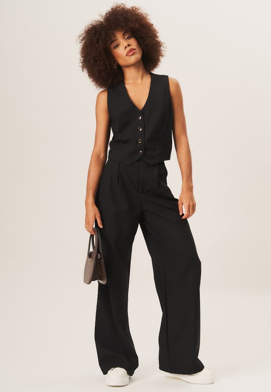 Complete your sophisticated look with our Tailored Single Breasted Waistcoat. Made with high-quality materials, this waistcoat adds a touch of elegance to any outfit. Pair it with our matching suit for a polished and fashionable appearance.