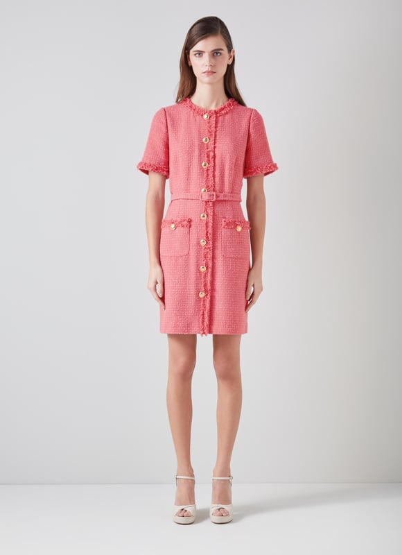 LK Bennett Allie Dresses, Blush The little tweed dress is a wardrobe classic, it will never fall out of style. Our new Allie dress is crafted in Europe from dark pink Italian tweed using recycled cotton, and is a short shift with a round neck, a raw edge trim, short sleeves, single-breasted hammered gold buttons, a fabric buckle belt and patch pockets on the skirt. Super chic and simple, wear it with stylish flat or a fun pair of platforms.