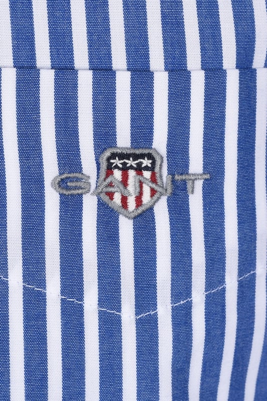 Gant Reg Poplin Stripe Shirt College Blue
100% cotton, regular fitting, with a box pleat to the back for added room and comfort. The durable and crisp poplin fabric looks and feels fantastic when worn, anf the very easy to style stripe is a must for your shirt rotation

100% Cotton
Poplin Fabric
Embroidered Badge
Style - 3000130