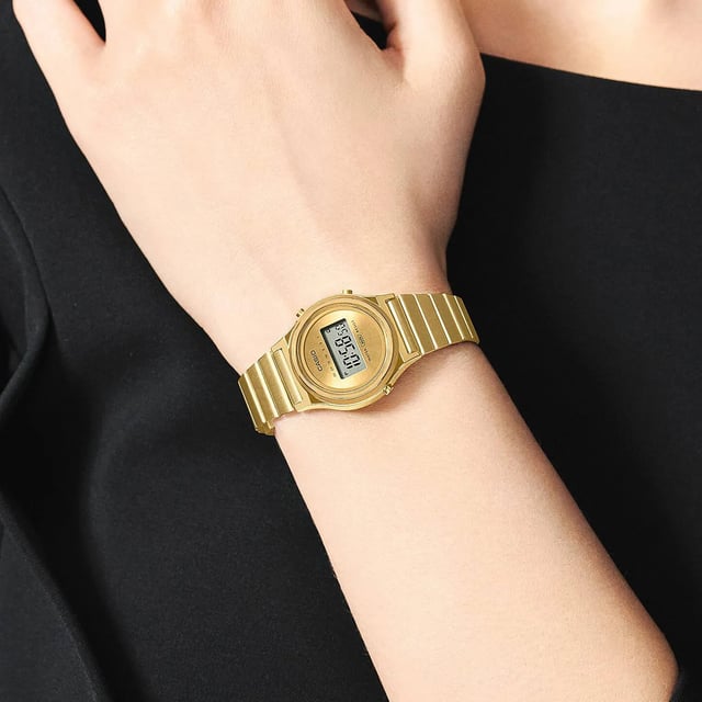 This Casio Casio Collection Vintage Digital Watch for Women is the perfect timepiece to wear or to gift. It's Gold 26 mm Round case combined with the comfortable Gold Stainless steel watch band will ensure you enjoy this stunning timepiece without any compromise. Operated by a high quality Quartz movement and water resistant to 3 bars, your watch will keep ticking. Sparkle in style with a smaller round watch featuring a minimalist design.  At just 26.3 mm in diameter, the petite round case delivers a delicate design for a stylish go-to accessory. This Digital watch has a calendar function: Day-Date , Stop Watch and Alarm High quality 19 cm length and 15 mm width Gold Stainless steell strap with a Folding Clasp Case diameter: 26 mm,case thickness: 7 mm, case colour: Gold and dial colour: Gold
