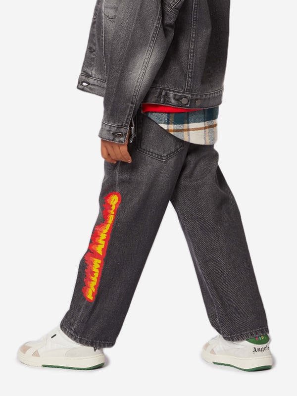 Palm Angels combine Italian craftsmanship with enigmatic Californian imagery. These boys black jeans are reflective of the label's passion for daring fits with an innovative twist. Depicted in a five-pocket denim design with a special 'Palm Angels' "Flames" print in orange, yellow and red on the left leg.  Regular Ft Wide Leg Fabric: 100% Cotton Lining: 65% Cotton, 35% Polyester
