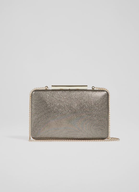 A modern interpretation of the classic box clutch, Dotty is designed for long-awaited parties. Crafted in Spain from beautiful fine glitter (which doesn't shed) in a luxurious bronze hue, it has a tapered, 3D rectangular shape, a chain shoulder strap and inside slip pocket. Wear it to add a subtle bit of shimmer and shine to any winter look.
