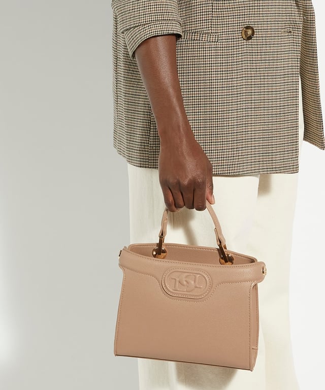 The Daily tote bag has turn lock closures that can be left undone for a more casual look. Simply secure the straps for a sleeker, smarter option. The central monogrammed lined compartment will house everything you need, whilst the magnetic closure will keep your belongings safe. The chain shoulder strap can transform the look from a shoulder bag to a cross body and adds to the versatility of this chic style.