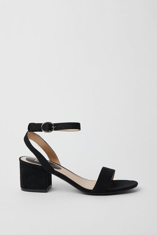 Wide fit design offers a comfortable and accommodating fit
Barely-there strappy silhouette with minimalist appeal
Mid block heel provides a modest lift and walkable height
Faux leather upper exudes a look and feel
Ankle strap with buckle closure ensures a secure fit

These versatile sandals are perfect for casual daytime outings or relaxed evening affairs. Pair them with a flowy midi dress or cropped trousers for a chic, on-trend look that transitions seamlessly from brunch with friends to an evening baby shower. The neutral hue complements a variety of ensembles, allowing you to showcase your personal style effortlessly.