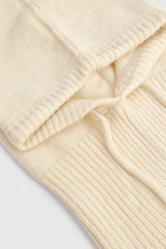 Cosy knitted balaclava-style hat
        Ribbed texture for added warmth
        Adjustable drawstring for a customised fit
        Extended neck coverage for extra protection
        Versatile design suitable for various winter activities
    
    Embrace the chilly weather with this snug and stylish balaclava-style hat from Boohoo. Perfect for those who crave both fashion and function, this piece offers comprehensive coverage from the crown of your head to your neck. The ribbed knit texture not only adds visual interest but also traps heat effectively, ensuring you stay toasty even on the coldest days. Style it with a chunky jumper and your favourite coat for a coordinated winter ensemble. Whether you're heading to a casual brunch with friends or embarking on a winter walk, this versatile hat adapts effortlessly to various occasions. Its neutral hue allows for easy pairing with your existing wardrobe, making it a must-have accessory for the fashion-forward woman who doesn't compromise on comfort.