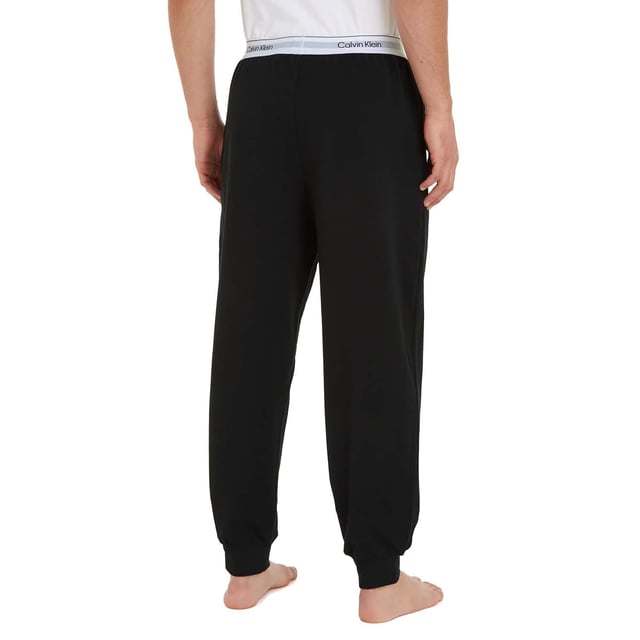 Mens Calvin Klein Lounge Joggers in black.- Branded elasticated waistband.- Side seam pockets.- Rib-knit cuffs.- Regular fit.- Ref: 000NM2302EUB1