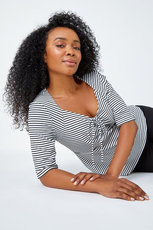Petite Stripe Ruched V-Neck Stretch Top from Roman. Embody daytime glamour with this timeless Petite piece! Our newest addition to the Petite collection is this cutesy stripe top, it features a unique sweetheart neckline and playful 3/4 length sleeves that are sure to make a versatile staple ready for your Spring wardrobe. This Petite top has a timeless ribbed texture which accompanies the stripe print throughout as well as a tie detail at the bust that provides a sophisticated flare. Wear with shorts and sandals for a holiday-ready style.