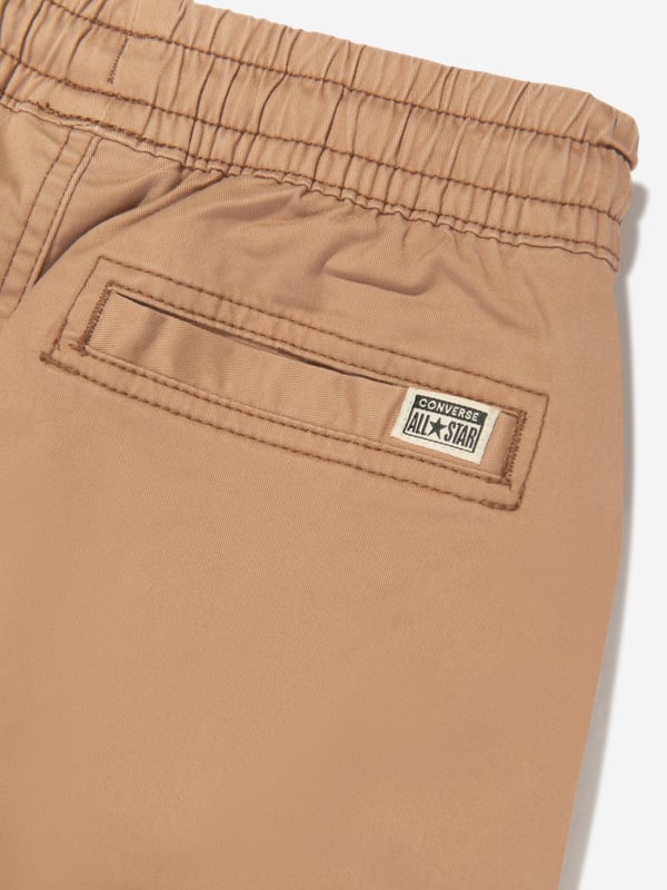 Introducing the Boys Lifestyle Woven Cargo Joggers in Brown by Converse. A chic wardrobe addition for your young man this SS2024. The key attributes include:‚ Urbane Design: Featuring a trendy cargo silhouette, these joggers offer a perfect blend of fashion &amp; function. ‚ High-End Quality: Made with premium, soft, and resilient material for optimum comfort and lasting wear.‚ Superior Detailing: With a distinctive Converse brand imprint, these joggers reflect a sophisticated yet playful style.‚ Versatility &amp; Comfort: Perfect for all-day activity, whether it's for casual outings or playful adventures.Elevate your boy's fashion game with these high-end Converse Lifestyle Woven Cargo Joggers in Brown. Order now for the era-defined style!