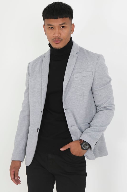 This blazer from Brave Soul is a stylish and sophisticated jacket that is perfect for a variety of occasions. With its single-breasted slim fit design and button details on the cuffs, it has a classic and timeless appeal. It features a pique texture, two lower pockets and one chest pocket. This blazer can be teamed with a shirt and chinos for a smart look or dressed down with a simple t-shirt and jeans.