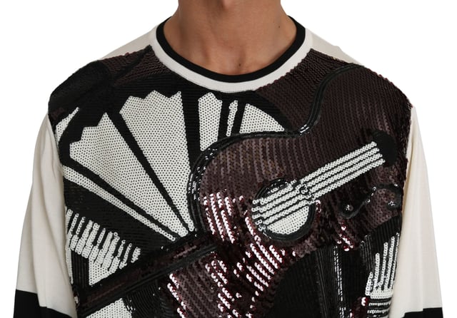 Varumärke: Dolce \u0026 Gabbana\n  Pullover-stil\n  Rund halsringning\n  Färg: Vit och svart med flerfärgade paljetter\n  Kollektion: New York Jazz Guitar\n  Logotypdetaljer\n  Tillverkad i Italien\n  Material: 68% silke 27% polyester 5% nylon\nMaterial: 68% silke 27% polyester 5% nylon
