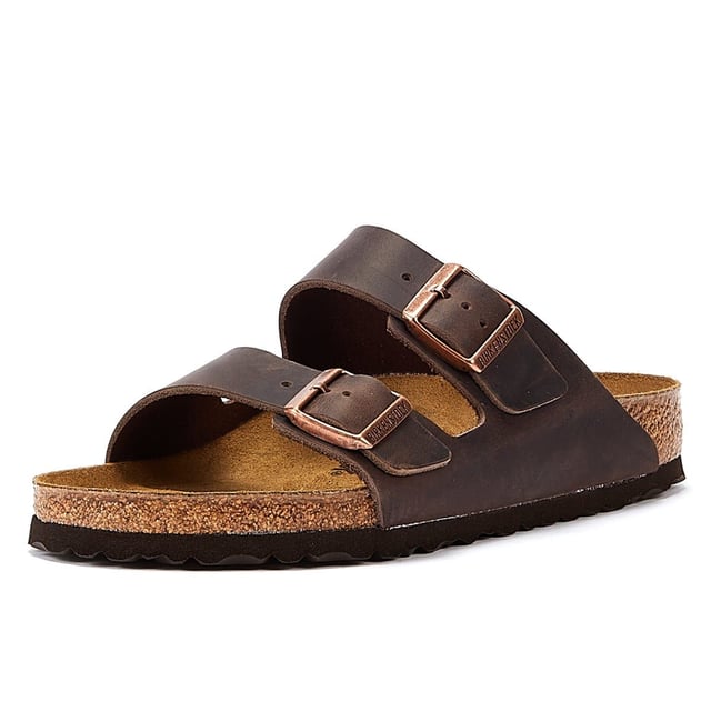 Birkenstock Arizona Habana Unisex Sandals The Birkenstock Arizona SFB Unisex Tabaco Brown Sandals are sandals feature two adjustable straps with metallic buckles that can be customized to fit the foot comfortably.The upper material is made of oiled nubuck leather which is durable and easy to maintain. The leather also has a soft velvety texture that feels comfortable against the skin. The footbed of the Birkenstock Arizona SFB Sandals is made of the brand's signature cork-latex material which is anatomically shaped to support the foot's natural contours. The footbed also has a deep heel cup a roomy toe box and a suede lining that helps wick away moisture keeping the feet cool and dry. The sole of the Birkenstock Arizona SFB Sandals is made of EVA a lightweight and flexible material that provides cushioning and shock absorption.