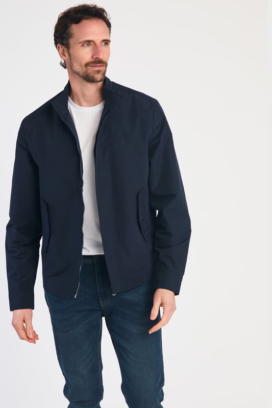 This Harrington Style Jacket by Kensington Eastside features a button-up collar, pop button sleeves, and a durable PVC coating. The checked mesh inner lining enhances comfort, while two side pockets and an embroidered logo add style and functionality, making it a perfect choice for casual wear.