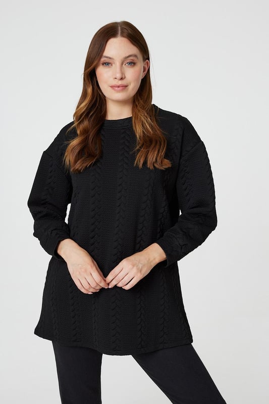 Get cosy in this cable knit oversized jumper. It has a round neck, long sleeves, an oversized longline shape and a thigh length hem. Pair with jeans or leggings for a classic style you can keep in your capsule closet for years to come.