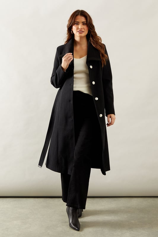 Elegant knitted collar for added sophistication
        Wrap design with button-through closure for versatile styling
        Long length offers maximum coverage and warmth
        Belted waist creates a flattering silhouette
        Functional side pockets for practicality
    
    This Wallis Knitted Collar Button Through Wrap Coat is the epitome of refined elegance. Perfect for the woman who appreciates sophistication without compromising on comfort, this coat is a versatile addition to any wardrobe. The wrap design allows for customisable fit, while the button-through closure adds a touch of classic charm. Style it over a sleek midi dress and pair with heeled boots for a polished look at formal events. For smart casual occasions, layer it over tailored trousers and a fine knit jumper, completing the ensemble with leather ankle boots. The long length and belted waist not only provide warmth but also create a striking silhouette that's sure to turn heads. Whether you're attending a business meeting or heading to a sophisticated dinner, this coat will ensure you look impeccably put-together while feeling effortlessly comfortable.