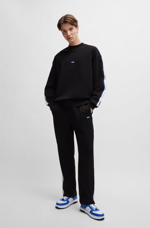 A fresh sweatshirt by HUGO Menswear. Designed in cotton terry  this regular-fit layer is trimmed with a branded patch and tape down the shoulders. mid weight french terry like rectangle logo story - HUGO BLUE logo patch on center chest - HUGO BLUE tape on arm and shoulder - ribbed collar  hem and cuffs