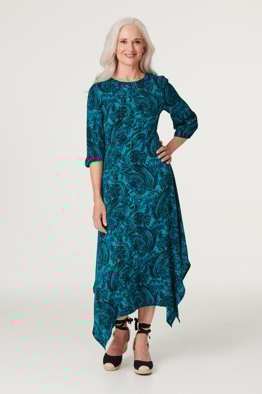 Add an chic asymmetric style to your dress collection with this chic paisley midi. It has a round neck, 3/4 sleeves, a keyhole back, a cinched waist and an elegant midi length skirt with a hanky hem detail. Pair with neutral heels for a daytime style you can wear for anything from lunch with the girls to a day at the races.