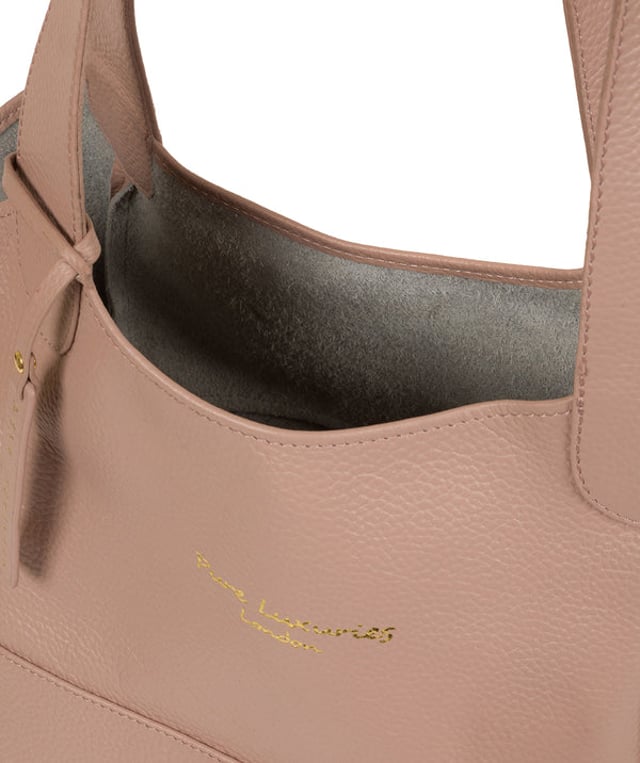 Crafted from supple natural leather, the 'Freer' tote bag from Pure Luxuries London is perfect for any occasion, day or night. The main compartment comes with an unlined and exposed leather interior for a soft to the touch feel with plenty of space for your essential items. A simple and elegant design with a beautifully soft pebble grain finish that is adorned with matching leather carry handles and furnished with the gorgeous Pure Luxuries London hnging charm and embossed logo.
