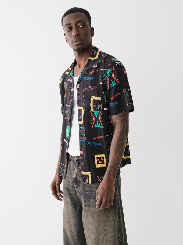 Grab your luggage and head to somewhere tropical in the Resort Print Camp Collar Shirt. Crafted from a soft woven fabrication, this men’s shirt features an allover conversational resort print, camp collar, short sleeves, and button-front closures.