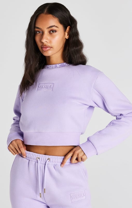 inchLilac Crop SweatshirtCropped fitSoft touchEmbroidered patchCrew neckPrinted neckbandMachine wash67% Cotton 33% Polyester inch