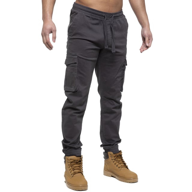 Enzo Mens Elasticated Waist Stretch Cuffed Jeans. Features a 5 Pocket Design. 2 Slash Pockets, 1 Back Pocket 2 Front Cargo, Bellow Side Pockets With Velcro Fastening. Elasticated Waist With Adjustable Drawstings. Cut and Sew Design On Leg. Cuffed Ankle