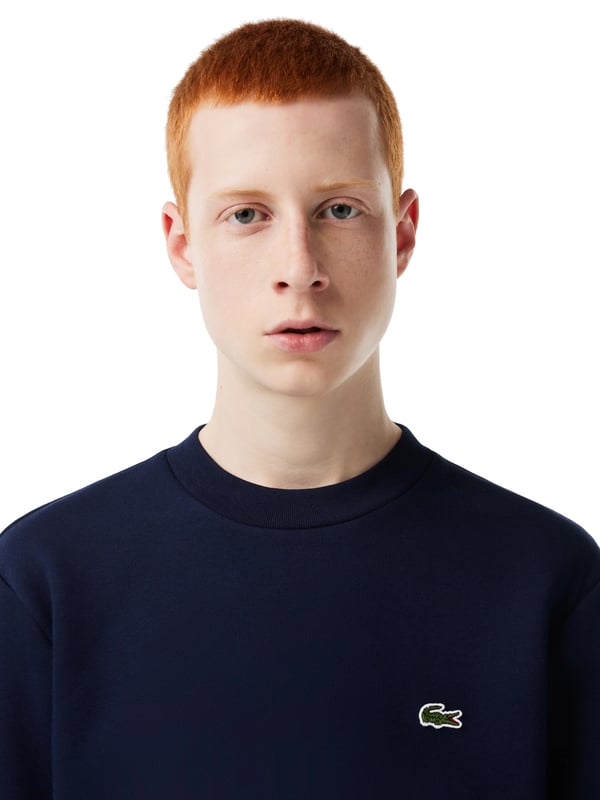 Solid-colored sweater with a round neckline, ribbed cuffs and subtle logo patches in a regular fit.