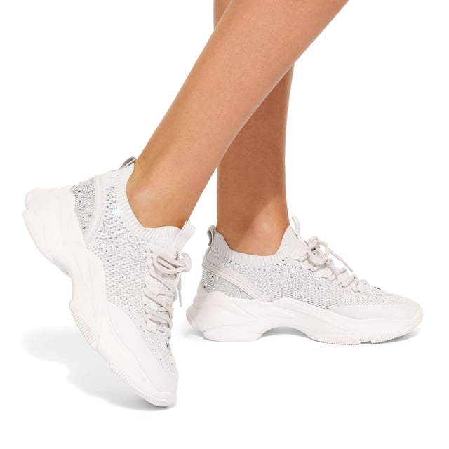 This KG Kurt Geiger Lively Gem sneaker is a bone knitted sneaker which is embellished with silver crystals. There is gunmetal branding across the upper and embossed branding on the heel.