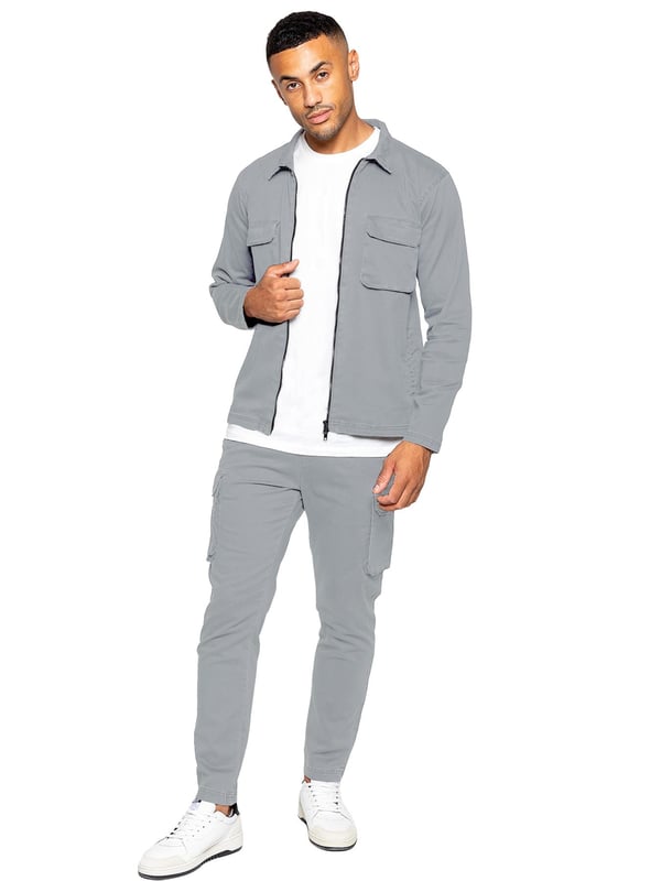 Enzo Mens Cargo Outfit Set. Long Sleeved, Zip Up, Collared, Cargo Overshirt. Two Front Flat Cargo Pocket With Velcro Fastening. Two Side Welt Pockets. Stitched Trims On Sleeves And Hemline. Set Completed With Cargo Trousers. Regular Fit, Straight Leg, Enzyme Wash. 5 Pocket Design. 2 Side Pockets, 2 Cargo Pockets With Velcro Fastening. Single Back Welt Pocket. Elasticated Waistband With Adjustable Drawstring