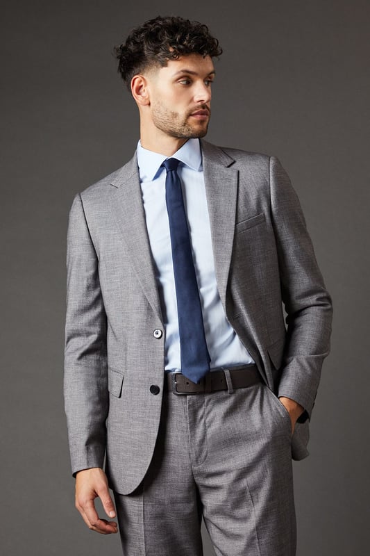 Slim fit design for a modern, tailored silhouette
        Sharkskin texture adds subtle depth and interest
        Notched lapels and two-button closure for classic styling
        Flap pockets and chest welt pocket for practicality and style
        Versatile mid-grey hue suitable for various occasions
    
    This Burton slim fit suit jacket radiates sophistication and versatility, perfect for the modern gentleman who appreciates timeless style with a contemporary edge. The sharkskin texture lends a subtle depth to the fabric, catching the light in a way that adds intrigue to your ensemble. Pair it with the matching trousers for a complete look that's ready for the boardroom, or dress it down with dark denim for smart-casual events. The jacket's slim cut flatters the physique, creating a sharp silhouette that's ideal for everything from important business meetings to after-work drinks with colleagues. Accessorise with a crisp white shirt and a bold tie to make a statement, or opt for a light blue shirt for a softer approach. This versatile piece is a wardrobe essential for the man who moves effortlessly between professional and social settings, always looking impeccably put together.
