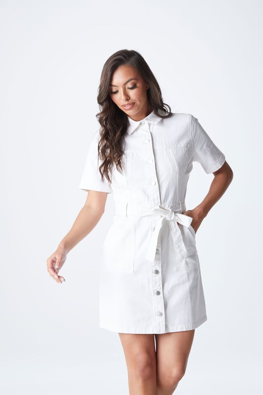 The perfect day out mini dress featuring a flawless fitted silhouette with a button and tie waist fastening. The ideal dress for a night out with friends to a holiday centrepiece, this dress will quickly become your favourite. Model is 5'6 and wears a size 8.