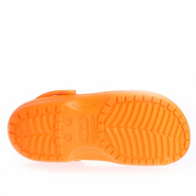 Juniors Crocs Classic Clogs in orange.- Slip on fastening.- Ventilation ports add breathability and help water and debris drain away.- Heel strap.- Fully molded Croslite™ material for signature Crocs comfort.- Lightweight  non-marking soles.- Ref: 20699183A