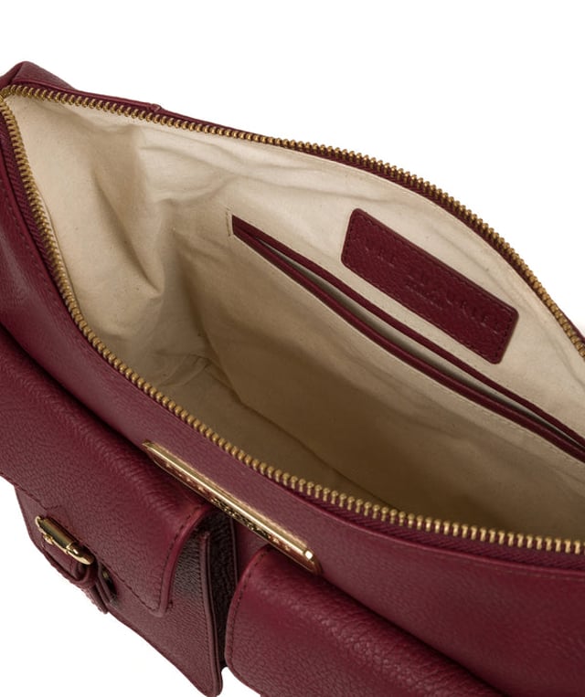 Crafted from leather that has soft pebble grain finish, the 'Jenna' shoulder bag from Pure Luxuries London comes with eye-catching gold-coloured fittings. The zip-over top secures a 100% cotton lined compartment, complemented by two internal pockets along with three external pockets that provide on-the-go storage; two of which are fastened with mock buckle press-studs. Comes with an adjustable matching leather strap and is adorned with the gold-coloured Pure Luxuries London charm and logo.
