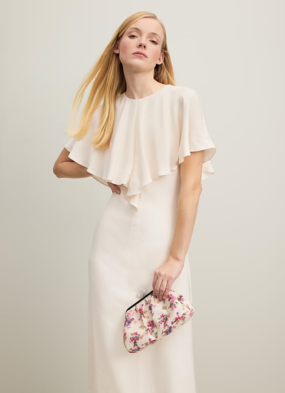 Light and luscious, the new Sadie dress in our Royal Ascot collection whispers elegance and timelessness. Crafted from a beautiful lightweight and floaty fabric in classic cream, it has a round neck with butterfly cape detail over the shoulders and a slim silhouette falling to the knee. Wear it for a day at the races, and all the big moments in your 2024 diary.