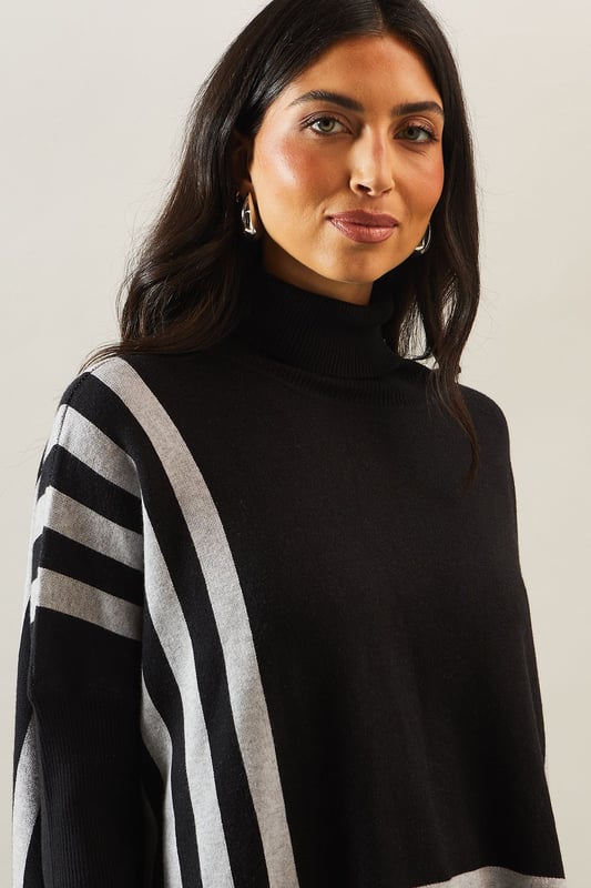 Chic striped roll neck poncho design
        Oversized, relaxed fit for ultimate comfort
        Elegant contrasting stripe pattern
        Long sleeves with dropped shoulders
        Versatile length suitable for various styling options
    
    Embrace sophistication and comfort with this striking striped roll neck poncho from Wallis. The oversized silhouette offers a relaxed fit, perfect for those who appreciate both style and ease. The elegant contrasting stripe pattern adds visual interest, while the long sleeves with dropped shoulders contribute to its laid-back charm. Ideal for casual events and family gatherings, this versatile piece can be styled effortlessly. Pair it with slim-fit trousers and ballet flats for a polished daytime look, or layer it over a fitted dress with ankle boots for a more refined ensemble. The poncho's adaptable length allows for various styling possibilities, making it a wardrobe staple for the fashion-forward woman who values both glamour and practicality in her everyday attire.
