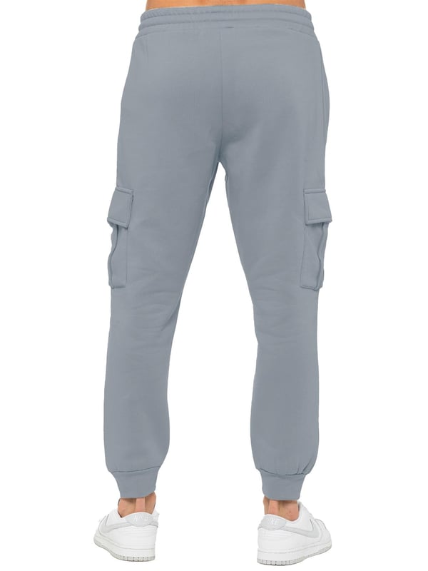Experience superior comfort and style with Enzo Men's Regular Fit Cargo Joggers! Crafted with a brushed back inner fleece lining, these joggers are designed to keep you cozy all day long. Perfect for casual wear, they feature convenient 2 side slash pockets and 2 cargo pockets, providing ample storage space for your essentials. Stay on-trend with the cuffed leg design, offering a modern silhouette and added comfort.