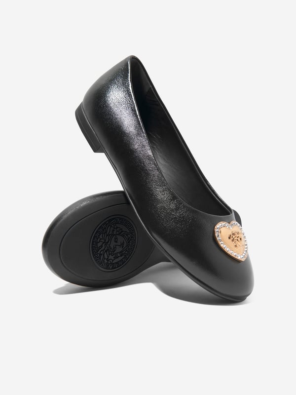 Versace encapsulate their daring aesthetics with a bold unapologetic attitude. These girls heart logo pumps on black are reflective of the luxury Italian label's experimentative approach. Crafted in refined materials, they feature crystal-embellished, heart-shaped Medusa charms at the toes. Both cute and stylish, they will be her favourite to wear at school and other weekend occasions.  Made In Italy Heart Medusa Charm Crystal Detail Round Toe 72% Viscose, 28% Silk 100% Calf Leather 100% Rubber