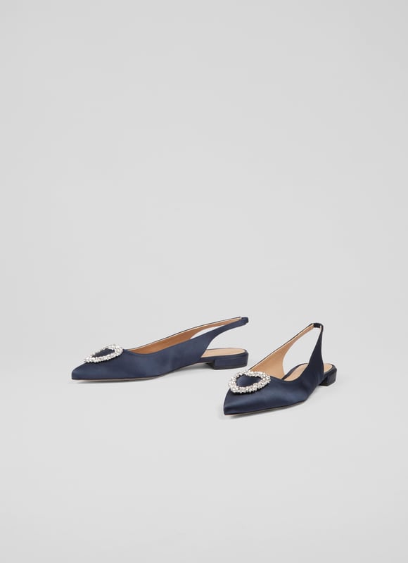 The definition of a 'fancy flat', the Luana slingbacks can elevate almost any look this spring/summer season with their subtle sparkle. Crafted in Spain from sumptuous navy blue satin, they have a pointed toe, a heart-shaped silver crystal brooch designed exclusively for LKB, an elasticated slingback, and a flat heel. Wear them to dress up a pair of jeans, or with dresses when you need a break from heels.